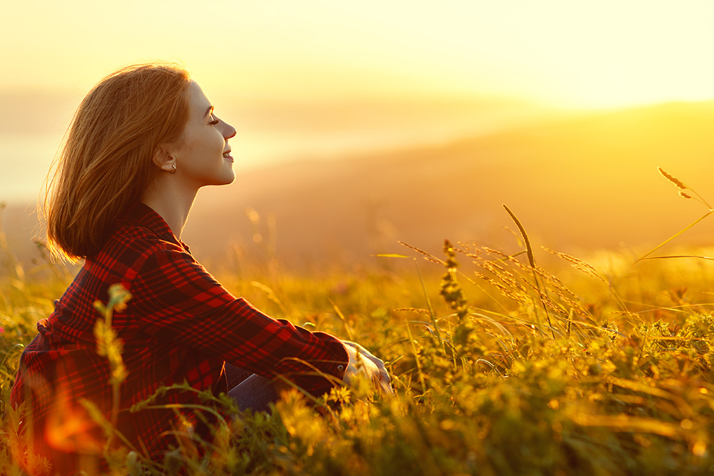 Woman meditating enjoying the presence of God