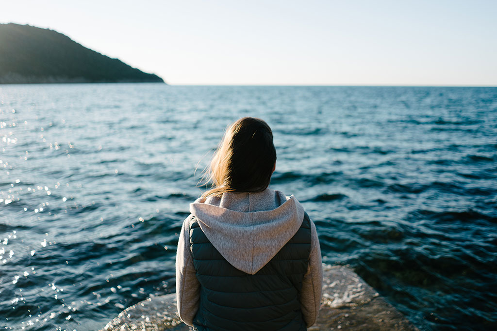 Woman looking out into the water