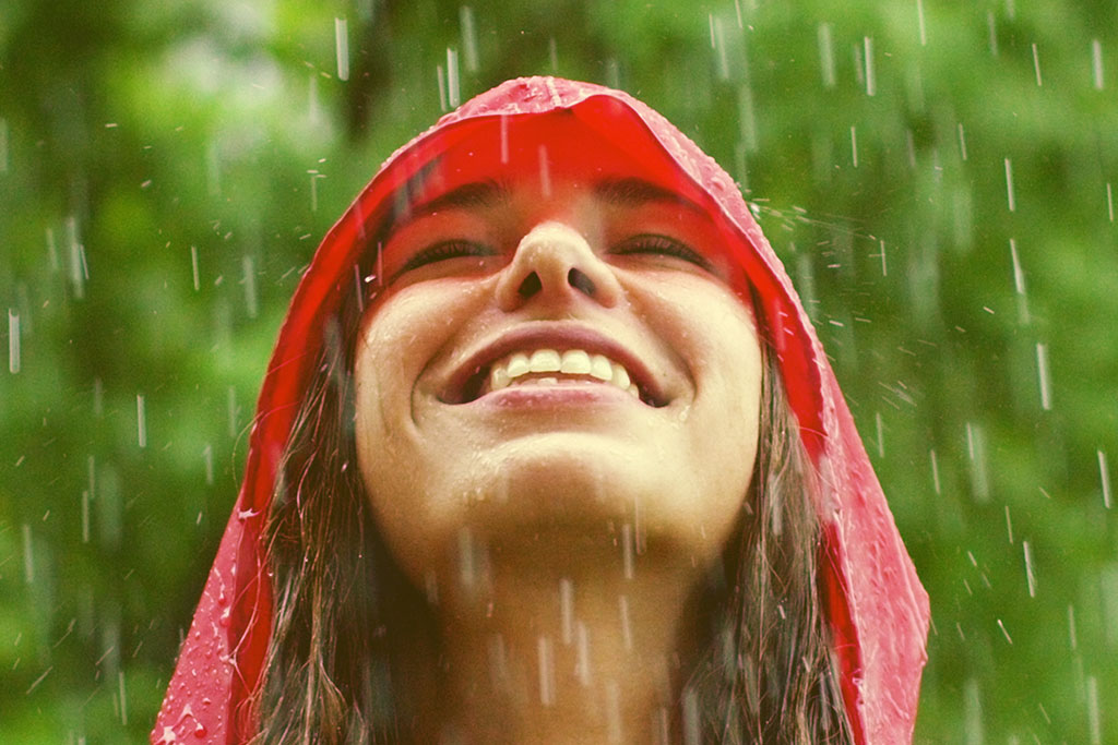 Woman smiling through the rain