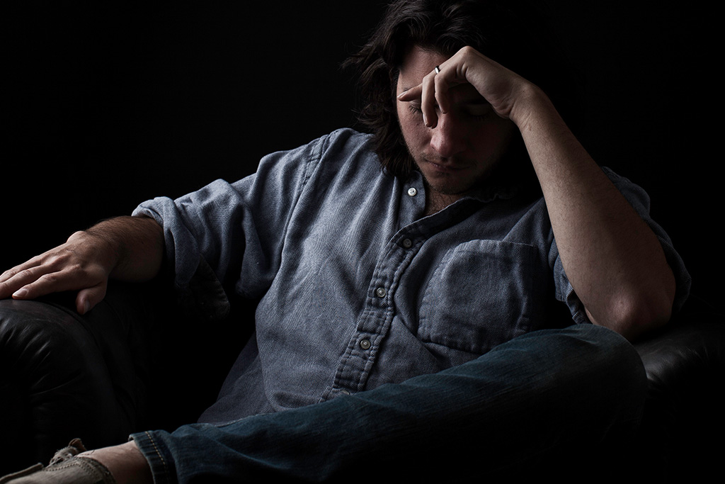 Man with head in hand worried