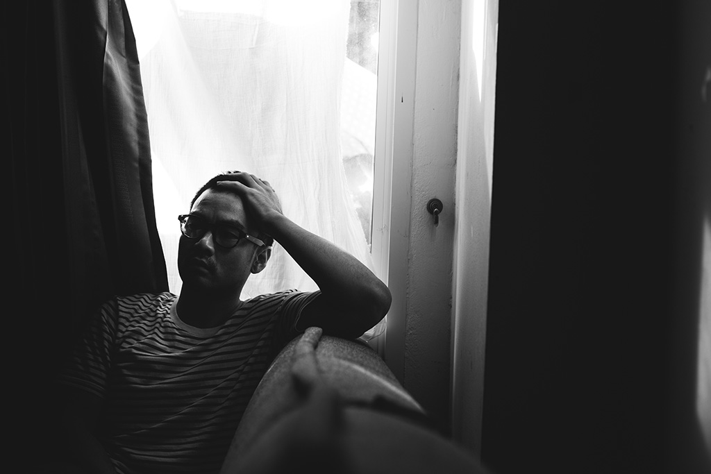 Man with head in hand in fear and anxiety