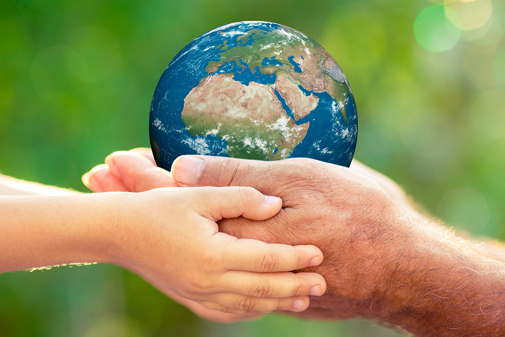 Hands holding a globe and representing take care of the earth