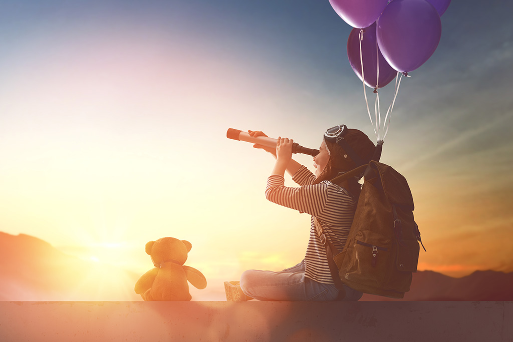boy looking out a telescope