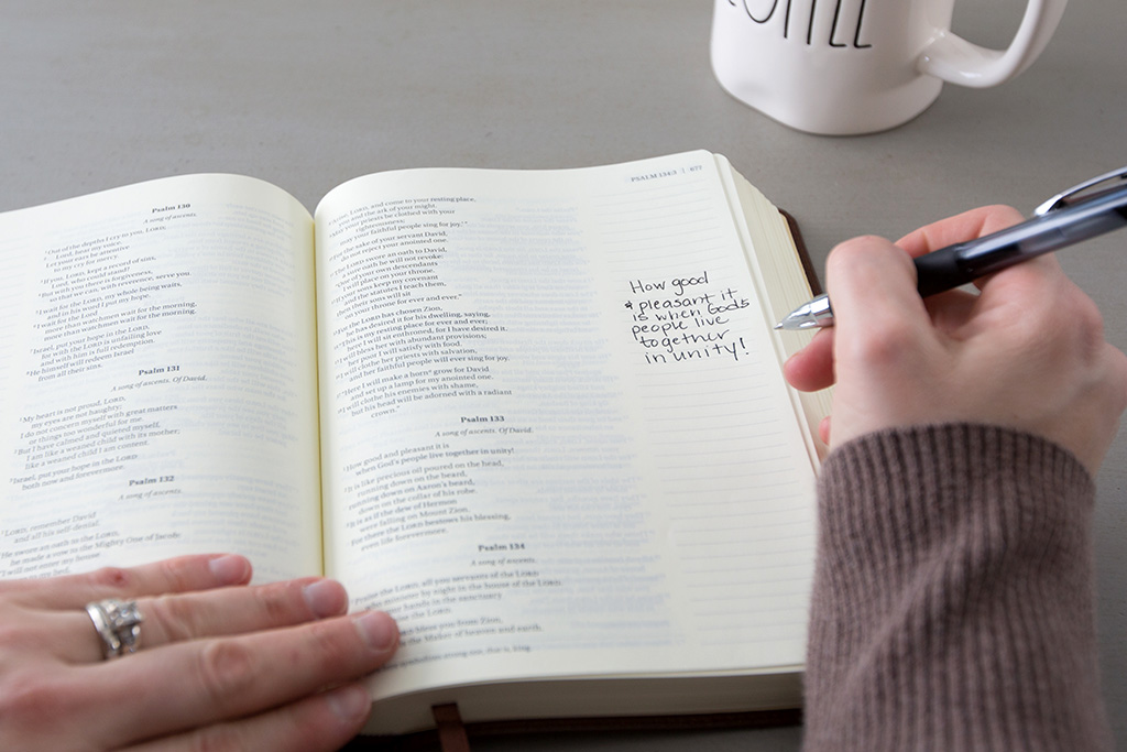 Woman writing a note in her Bible