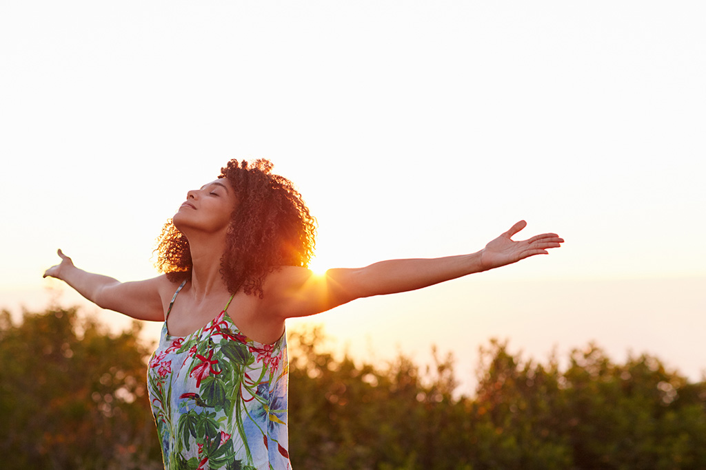 Confident woman with outstretched arms