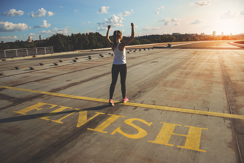 Woman crossing the finish line at end of a race