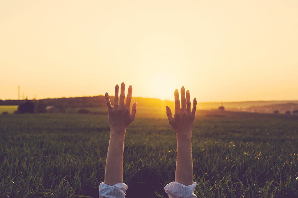 Hands up to the sky in surrender to God