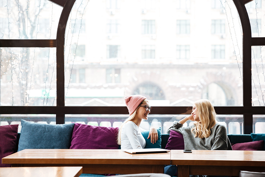 Two young women talking and encouraging one another