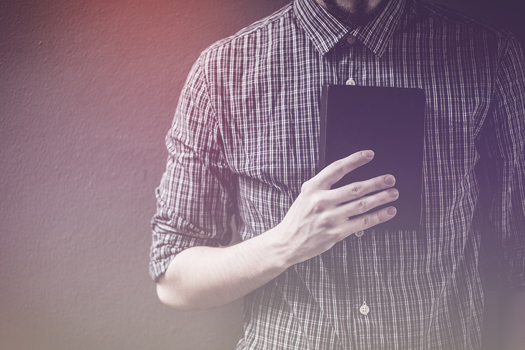 man holding Scripture close to his heart