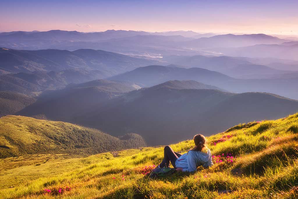 Woman praising God out in nature.