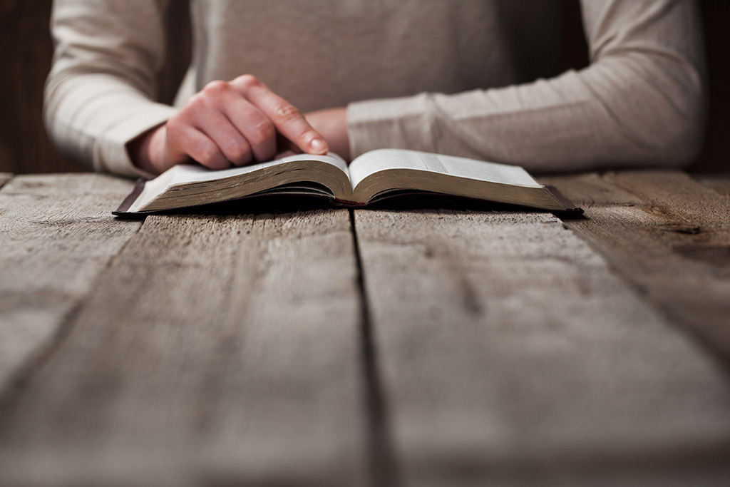 Man beginning to read the Bible