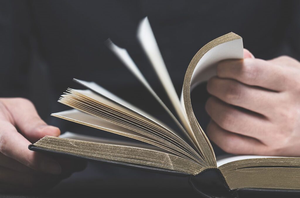 Where did the order of the books of the bible come from? - person flipping pages