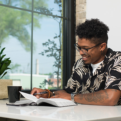 Man reading an NIV Text and Reference Bible